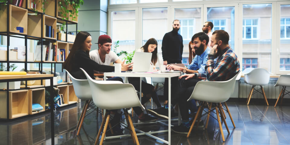 employees gathered at table